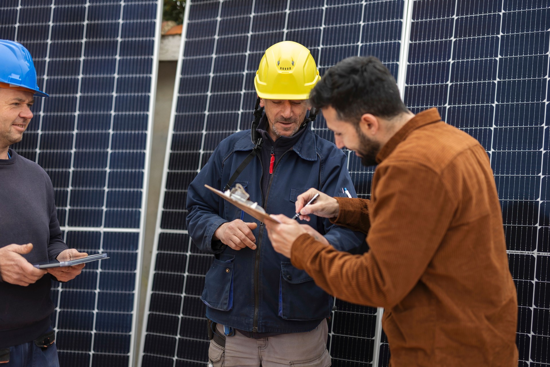 Solar panel engineers close the sale of a new installation with the signing of a contract