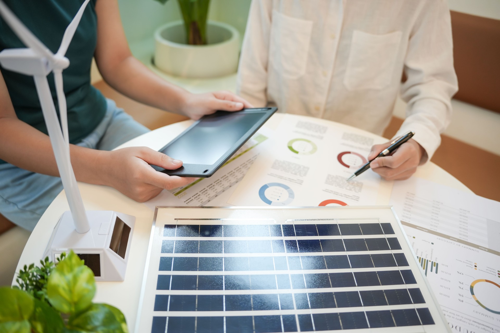 Solar panels green energy Business people working in green eco friendly office business meetingÂ creative ideas for business eco friendly professional teaching corporate people sustainable electricity