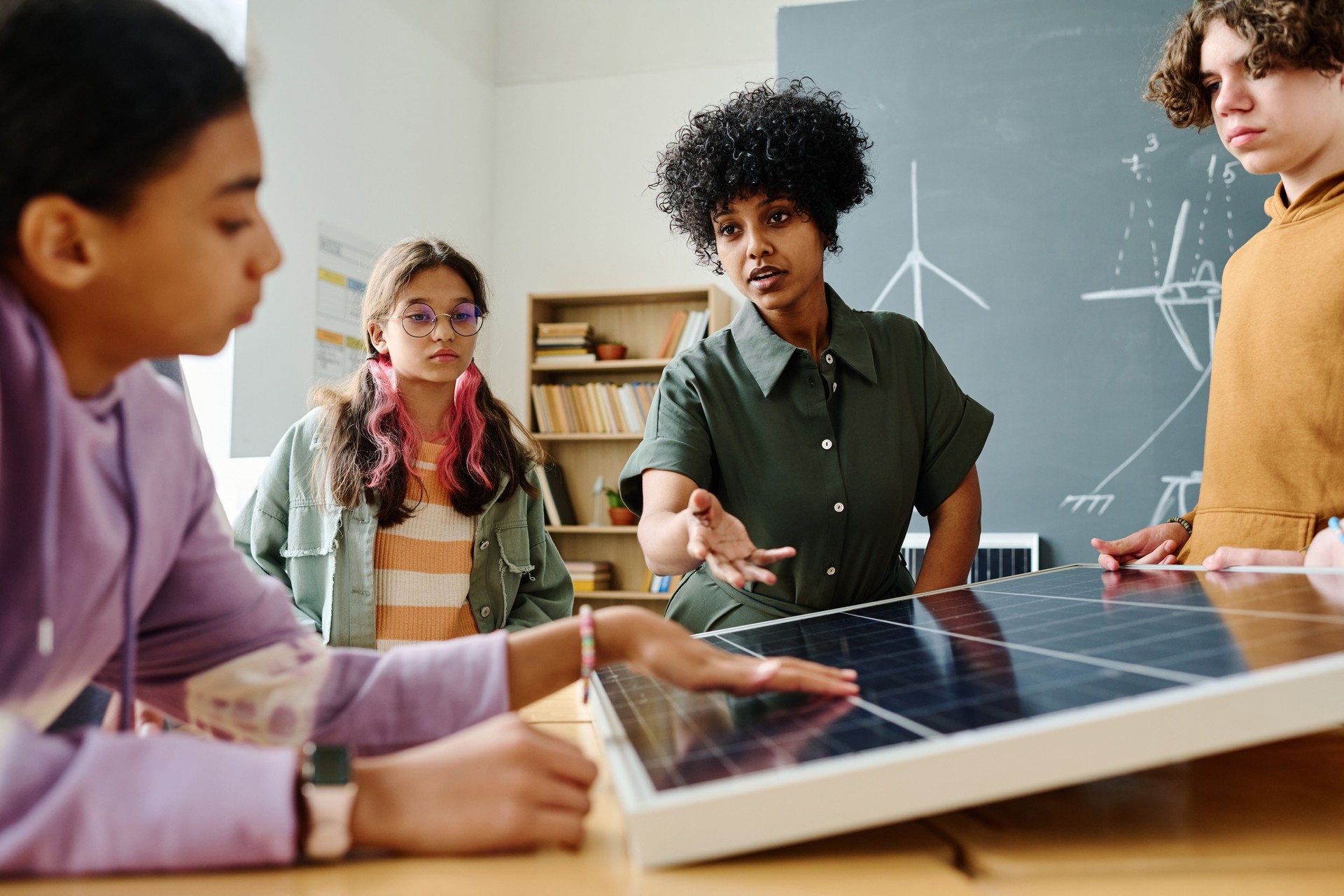 Teacher explaining the work of solar panel to students